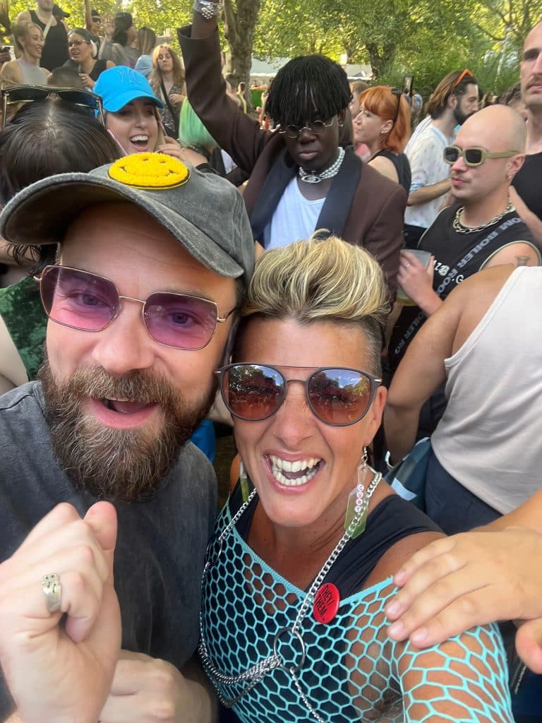 A recent picture of Em Conti hugging her friend David at a queer event