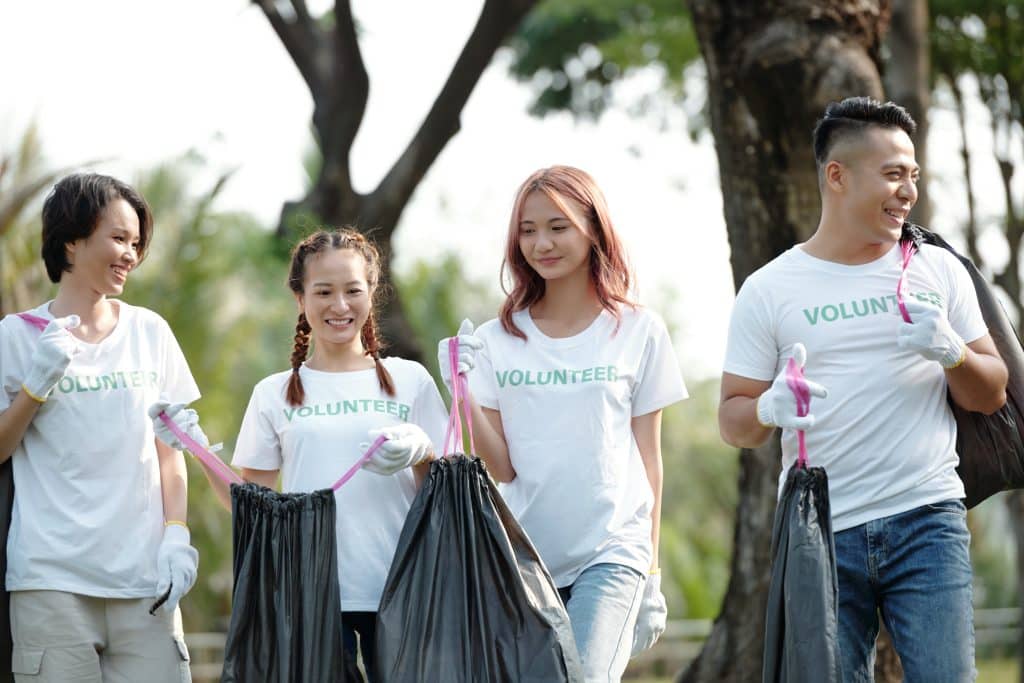 College students volunteering by picking up trash