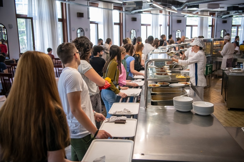 Students lined up for food at a cafeteria.