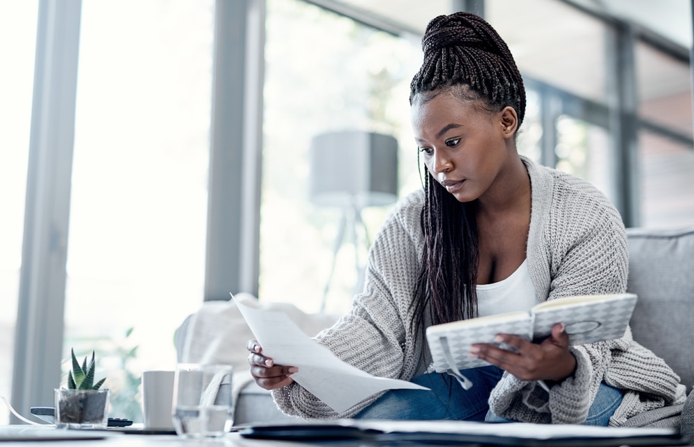 A young woman looking at paper documents