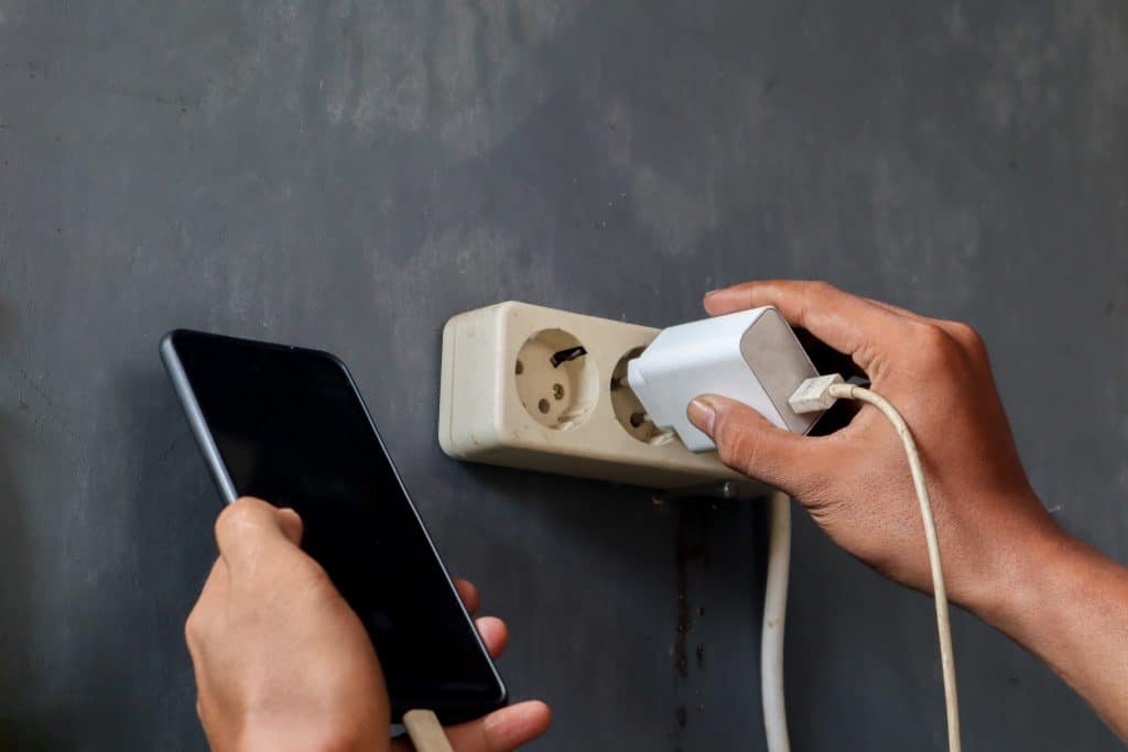 Person plugging in a phone
