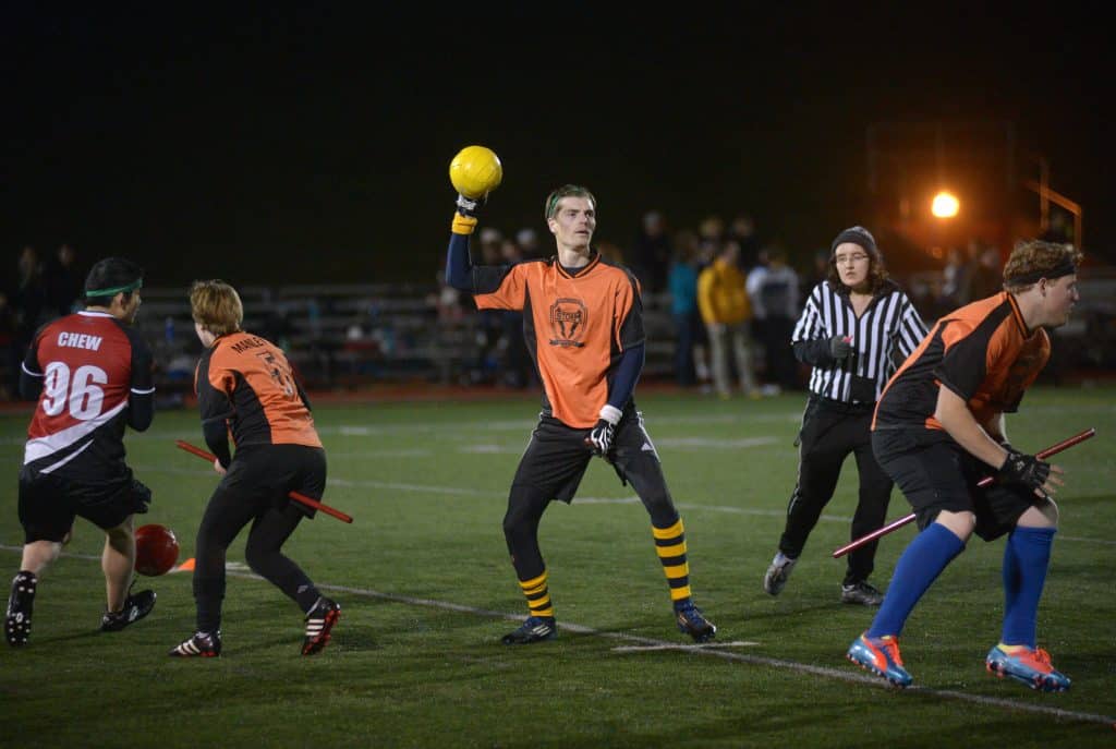 College kids with fake brooms play Quidditch