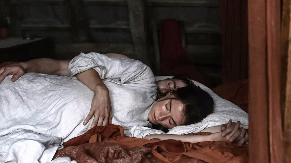 Agnes and William lie together. (Focus Features)