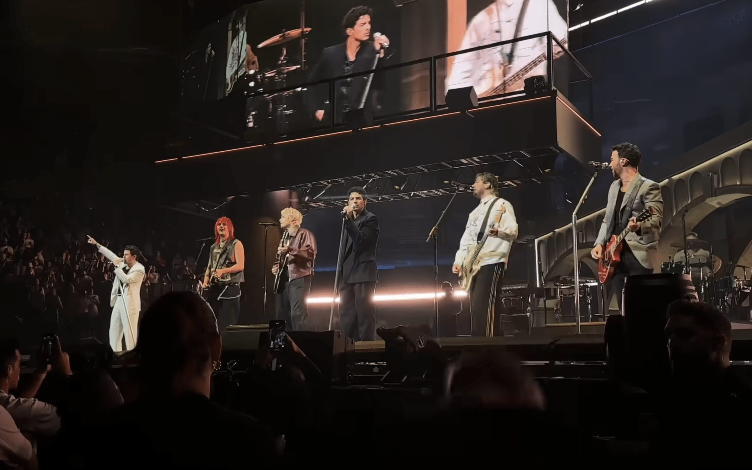 A still image of Australian band 5 Seconds of Summer performing with the Jonas Brothers