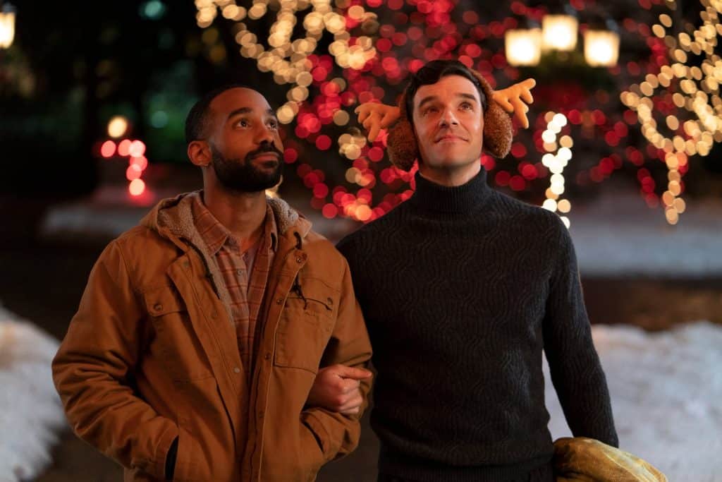 Peter and Nick linking arms looking at the holiday lights.