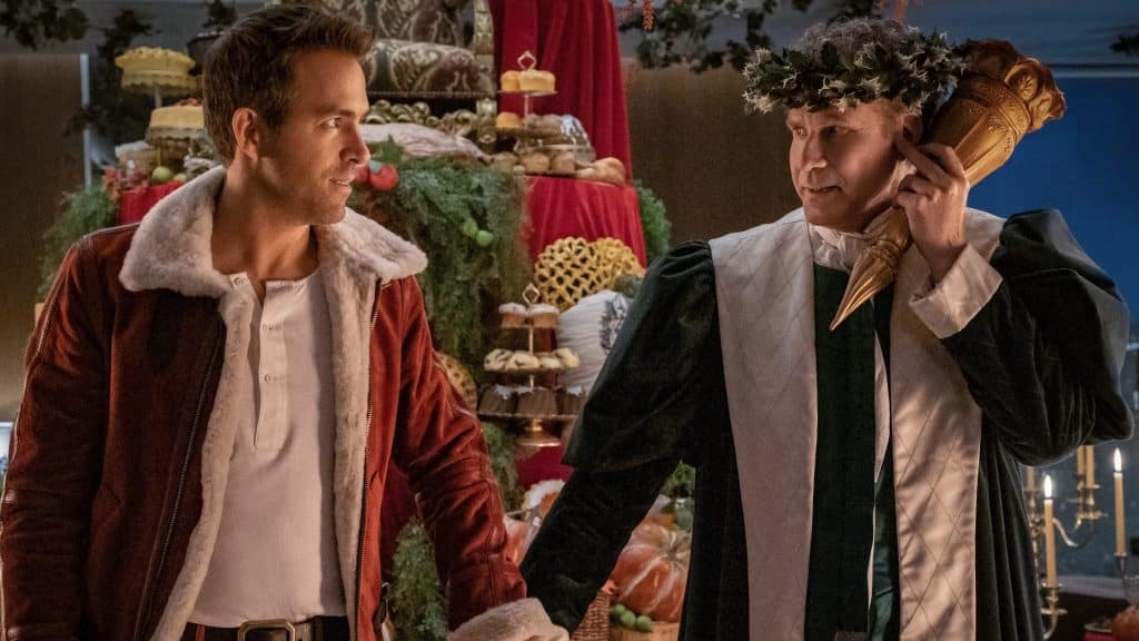 Will Ferrell and Ryan Reynolds holding hands at a Christmas party.