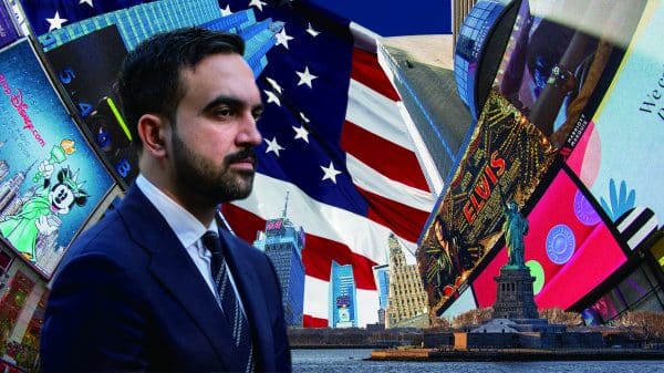 Zohran Mamdani is pictured with the American Flag and billboards from New York City in the background.