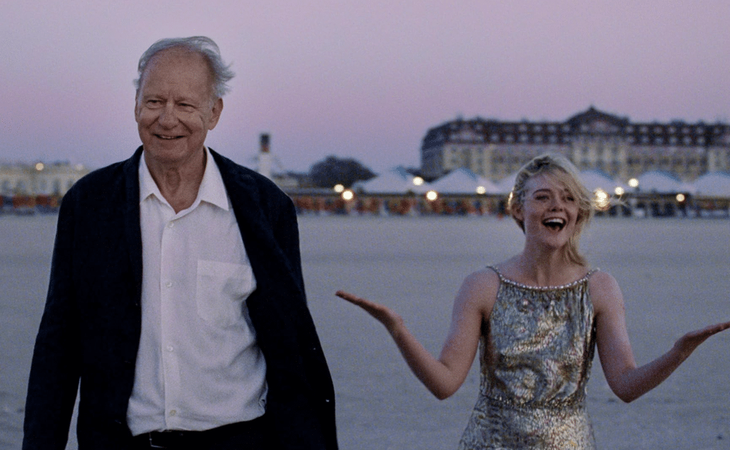 Gustav and Rachel are laughing on the beach. Credit: NEON.