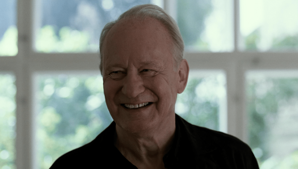 Stellan Skarsgård smiles brightly. Credit: NEON.