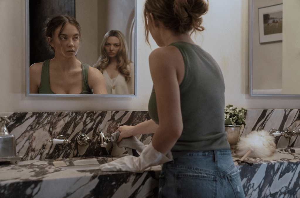 Millie (Sydney sweeney) notices Nina (amanda seyfried) in the mirror in the housemaid