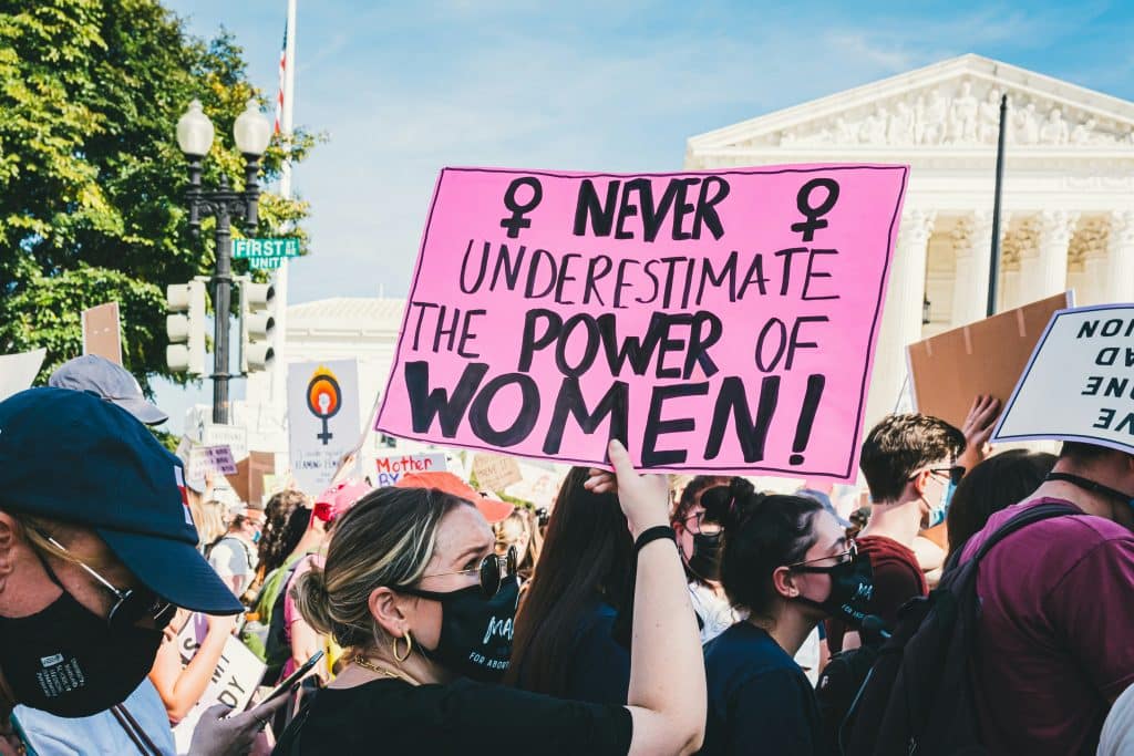 womans-rights-protest.jpg Protest sign reading “Never underestimate the power of women” held up during a women’s rights demonstration.