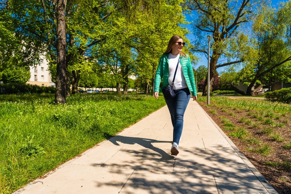 A woman going for a walk on a sunny day.