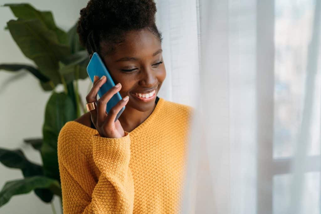 Woman cheerfully talking on the phone