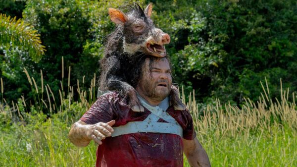 Jack Black gives a boar a piggyback. Credit: Sony Pictures.