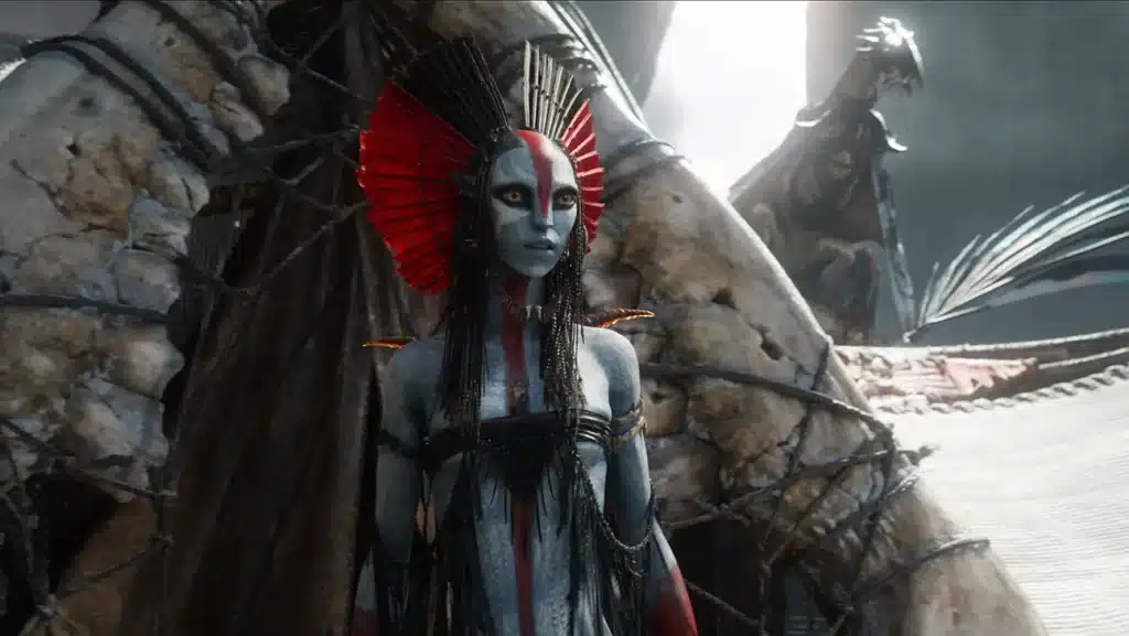 The image depicts the new antagonist of Avatar: Fire and Ash, Varang, emerging from a tent made of a giant jaw bone.