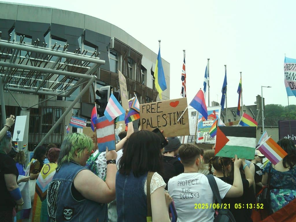 Pride march in Edinburgh. People holding up signs.