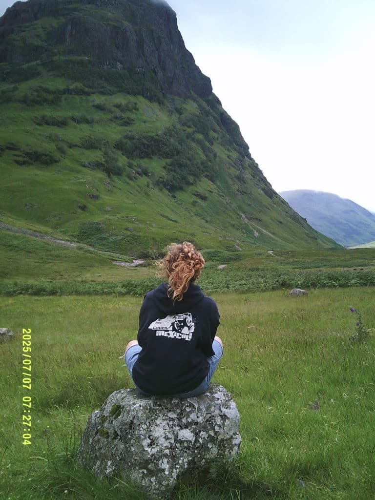 Picture of me (the writer) sitting on a rock at the Isle of Skye.