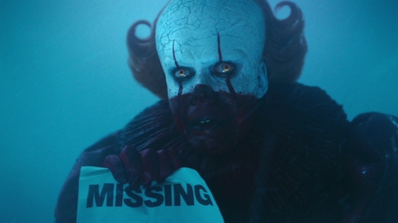 Pennywise holding up a sign