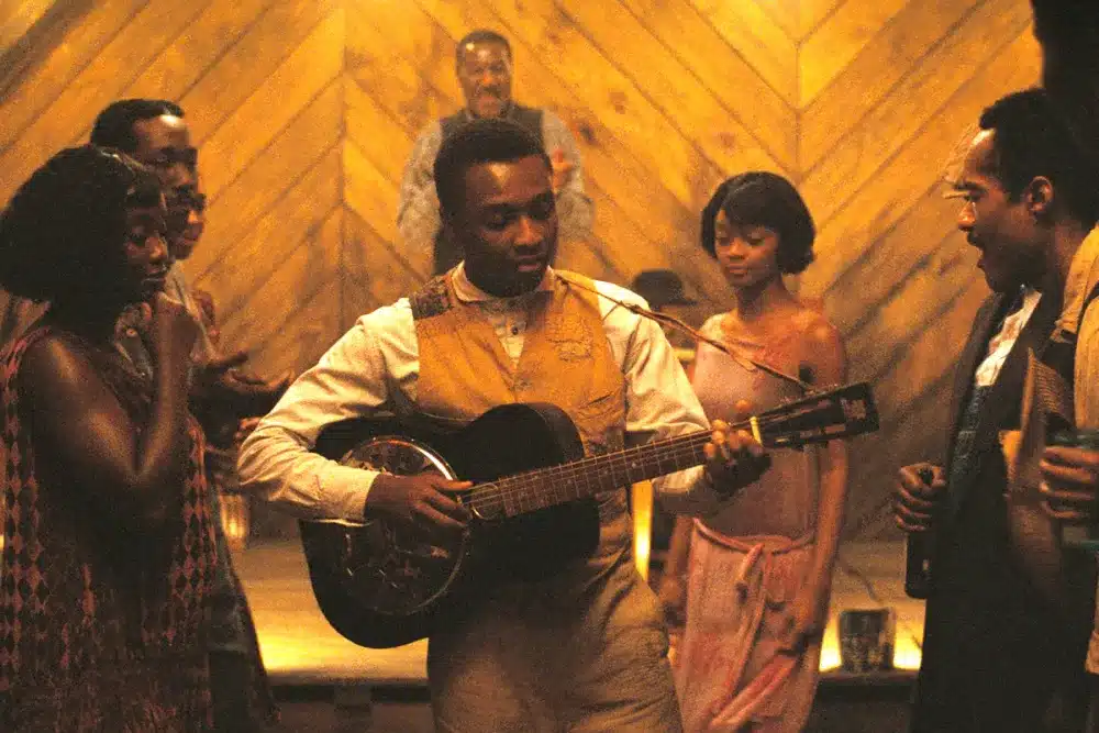 Preacher Boy and Delta Slim playing blues music in juke joint while others listen and dance