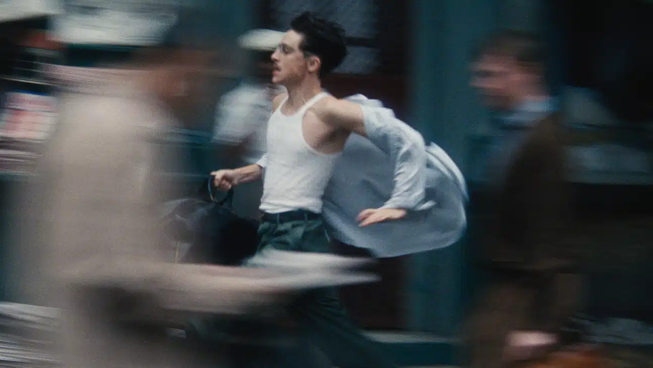 Timothee Chalamet runs through the streets.