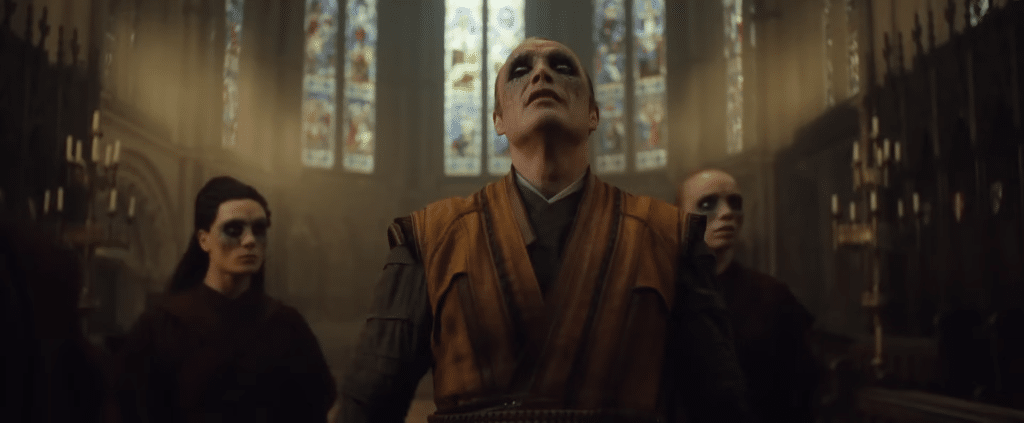 Mads Mikkelsen as Kaecilius, looks up at the ceiling of a large cathedral.