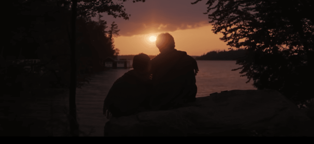 Two characters side by side watching the sunset