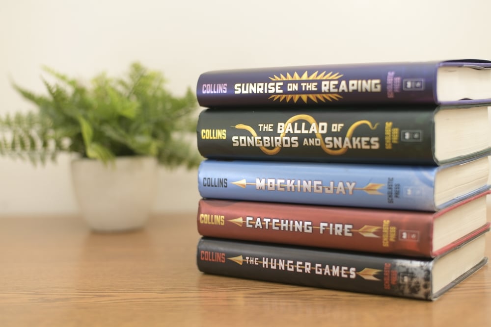 The Hunger Games series stacked neatly on a table