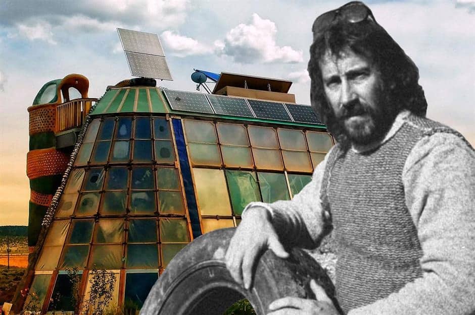 Earthship founder, Michael Reynolds, in front of an older Earthship build.