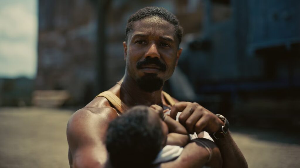Smoke (Elijah Moore) holding his baby