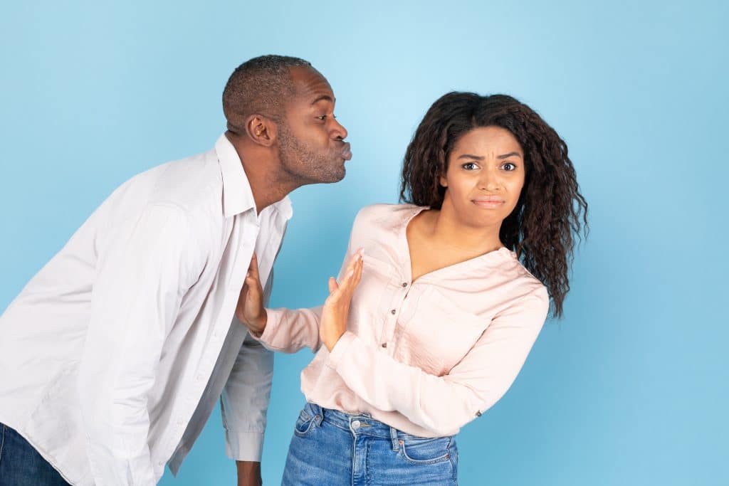 A girl being disgusted by a guy trying to kiss her. She has the ick.