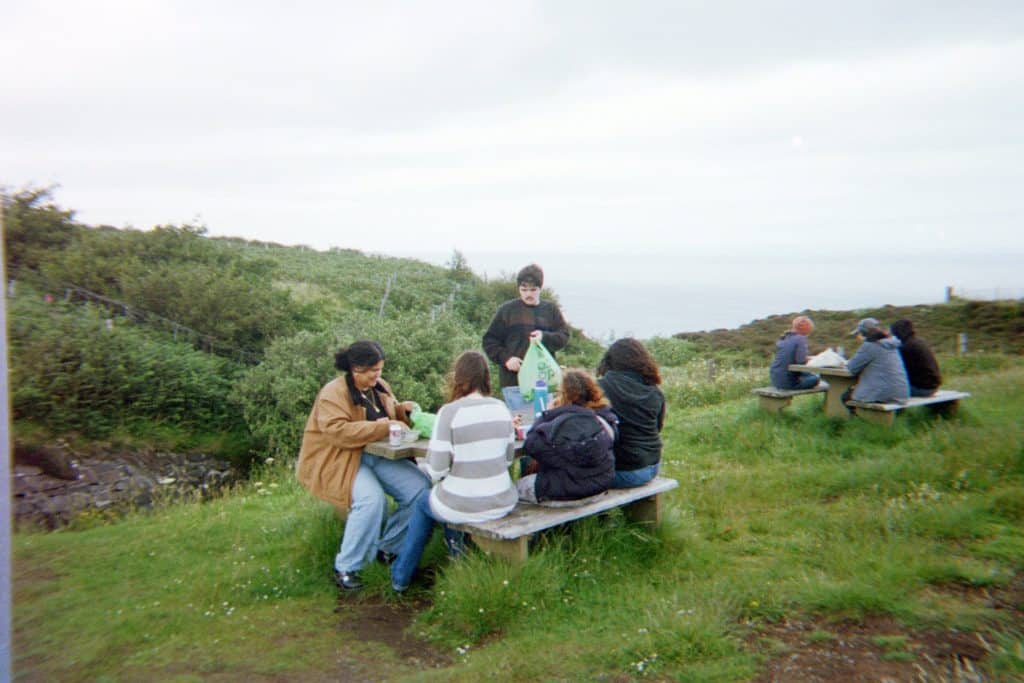 A study abroad group is having a picnic on the Isle of Skye.