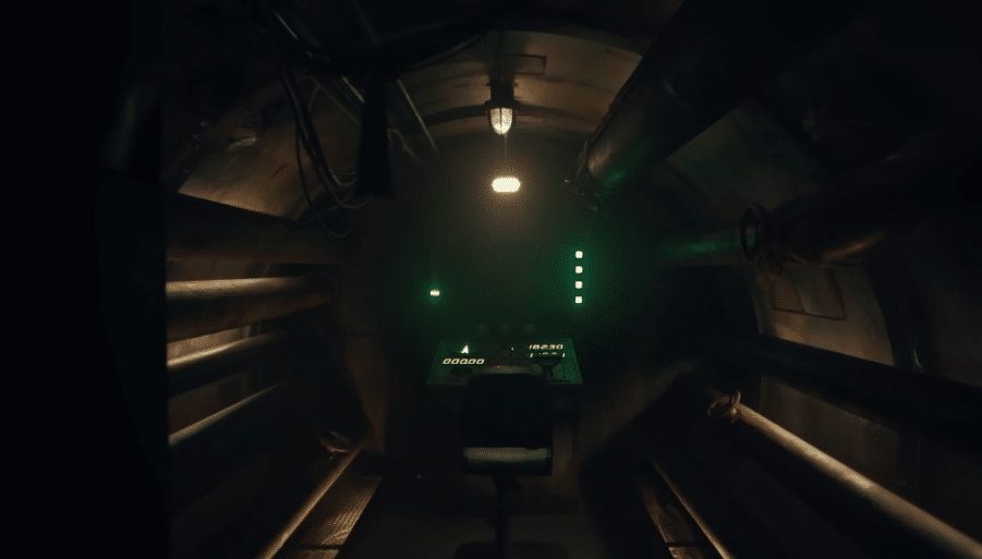 Image of an enclosed space with a control panel and chair sitting centre focus of the camera.