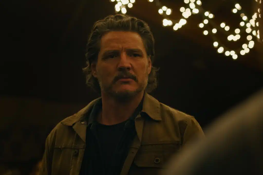 Actor Pedro Pascal looking at something in the distance during a scene from The Last of Us.