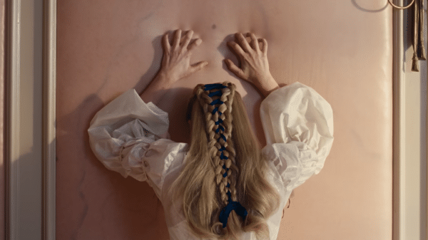 Margot Robbie as Catherine claws at the flesh-like wallpaper of the "skin room".