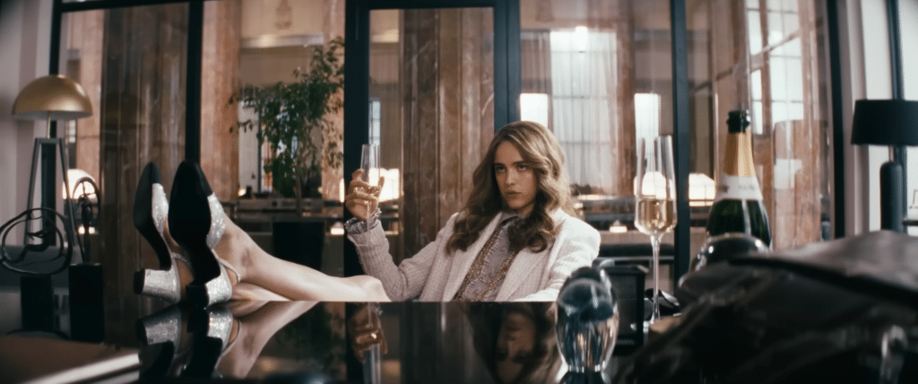 Julia (Margaret Qualley) sitting in Becket's office. Credit: YouTube/A24.