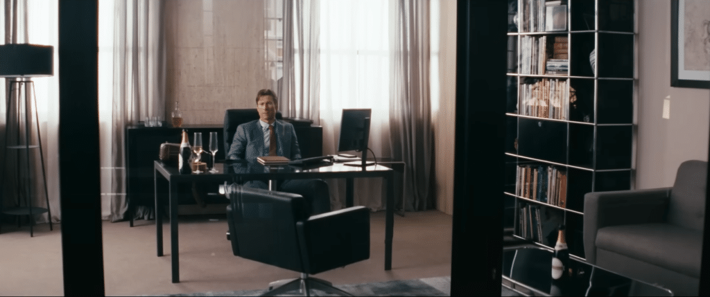 Becket sitting in his office. (Credit: YouTube/@A24)