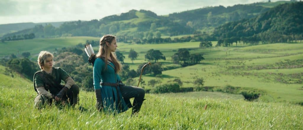 Actors Benjamin Evan Ainsworth and Bo Bragason positioned within a green field as promotion for the upcoming The Legend of Zelda film.
