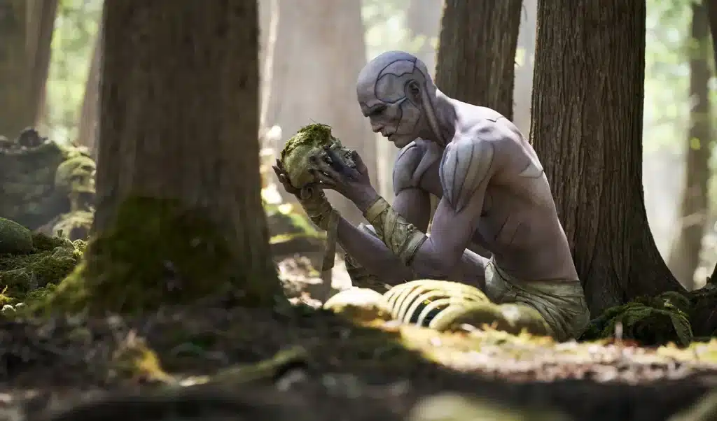 Jacob Elordi plays the Creature in Guillermo Del Toro's 'Frankenstein.' He is holding a human skull.