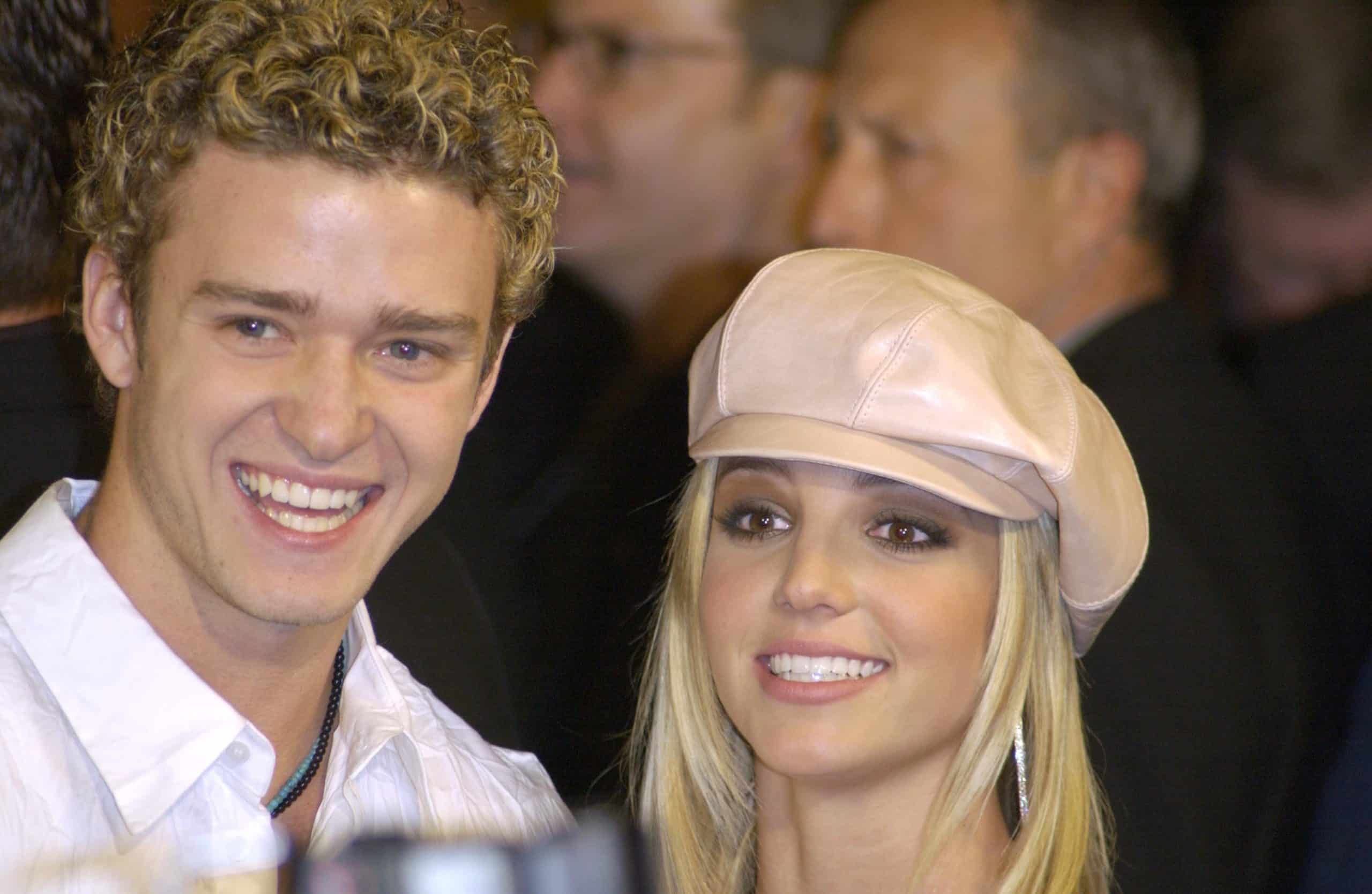 Justin Timberlake (left) and Britney Spears (right) smile, looking off to the side