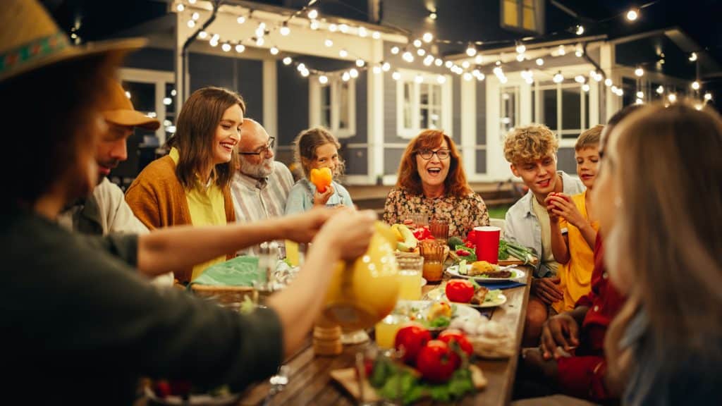 A laughing family sitting at a dinner table filled with food. The type of meal where questions about figuring out your course of study inevitably come up.