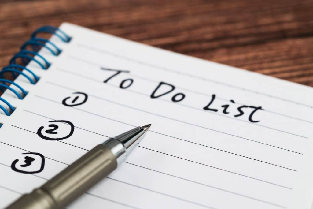 Piece of lined paper with a pen on it, titled "To Do List"
