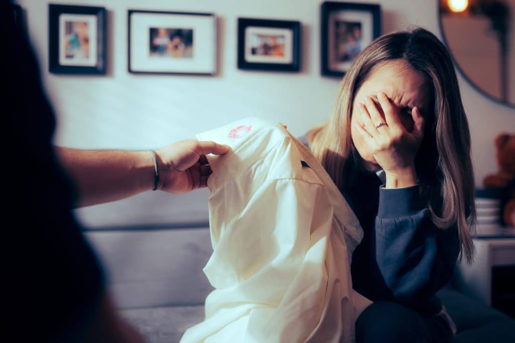 Finding lipstick stains on your partner's white button-down shirt is never a beautiful sight. // Credit: Nicoleta Ionescu / Shutterstock.