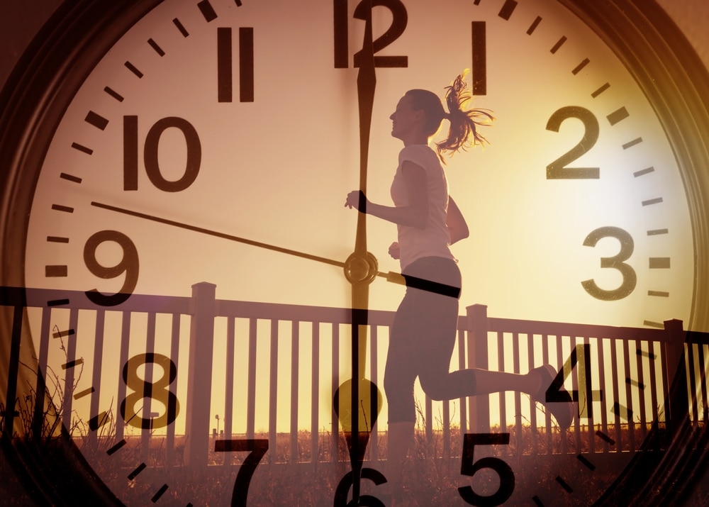 someone running with a clock behind them