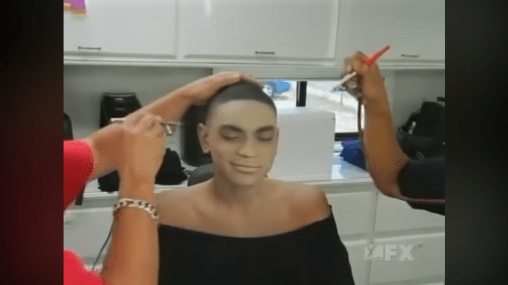 Nicholas Sparks from Black. White. having his white makeup be put on him.
