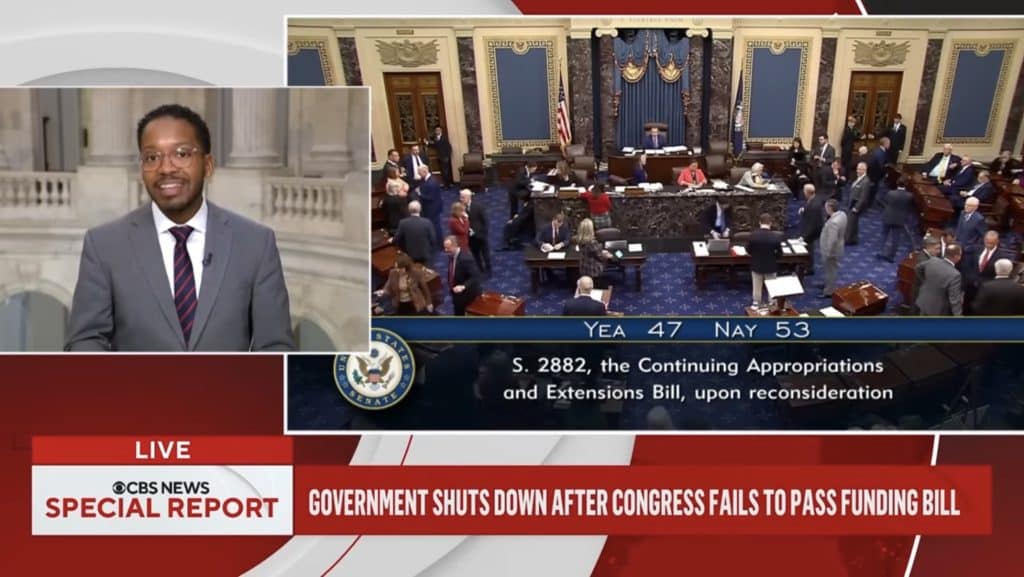 News Reporter talking on left. Senate camber vote on the left.