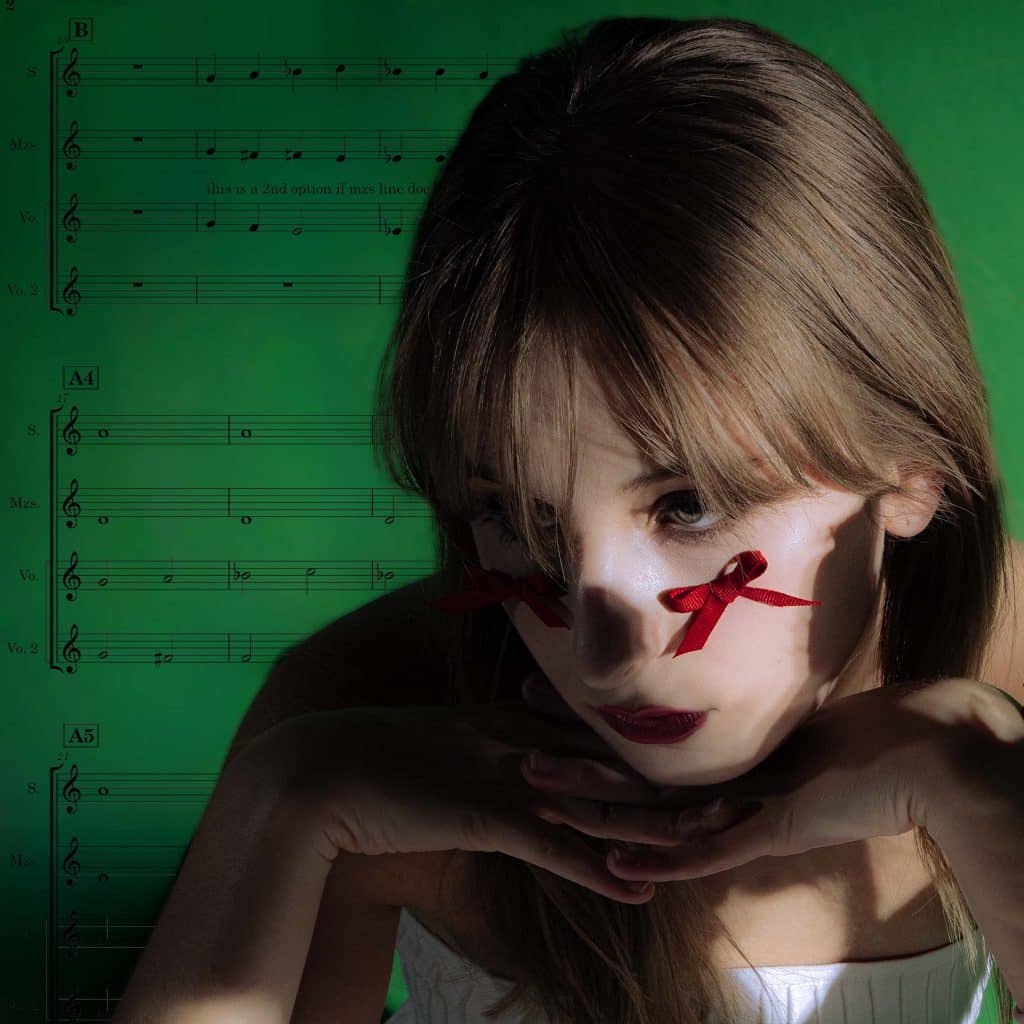 The author posed artfully in front of a sheet of music with a ribbon on her cheek.