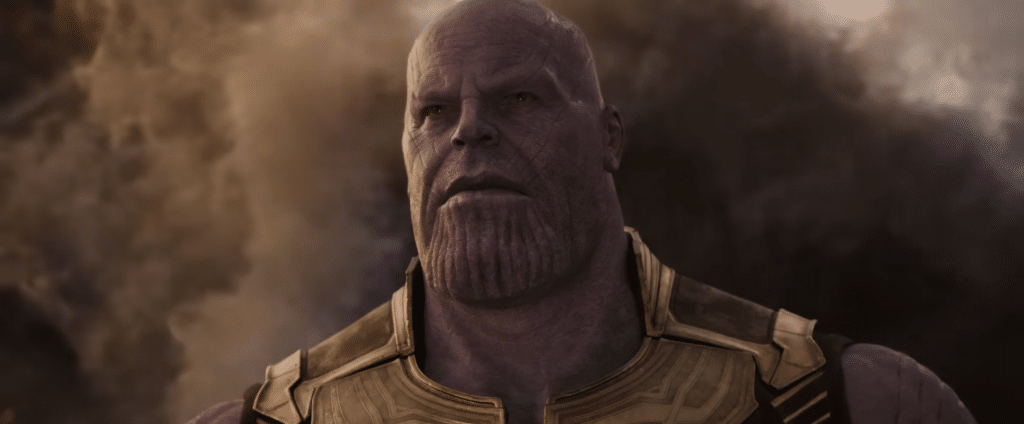 Thanos looking upwards into a light, with a background of smoke.