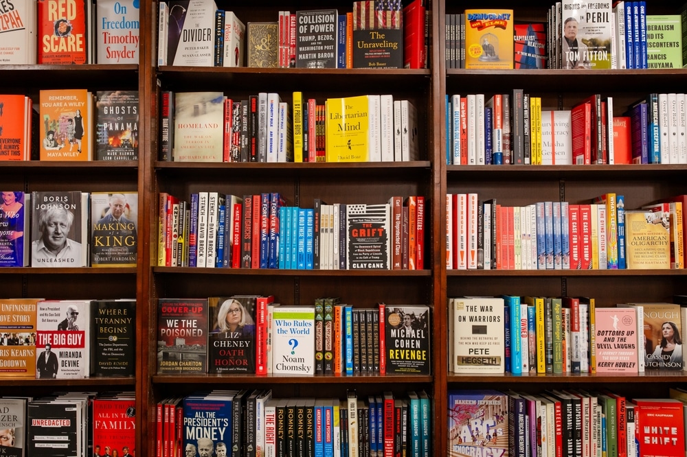 Stocked bookstore shelf with some books facing outwards