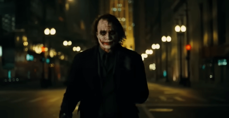Heath Ledger as the Joker walking in the middle of the road