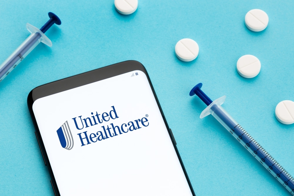 Phone with UnitedHealthcare logo on it and medicine
